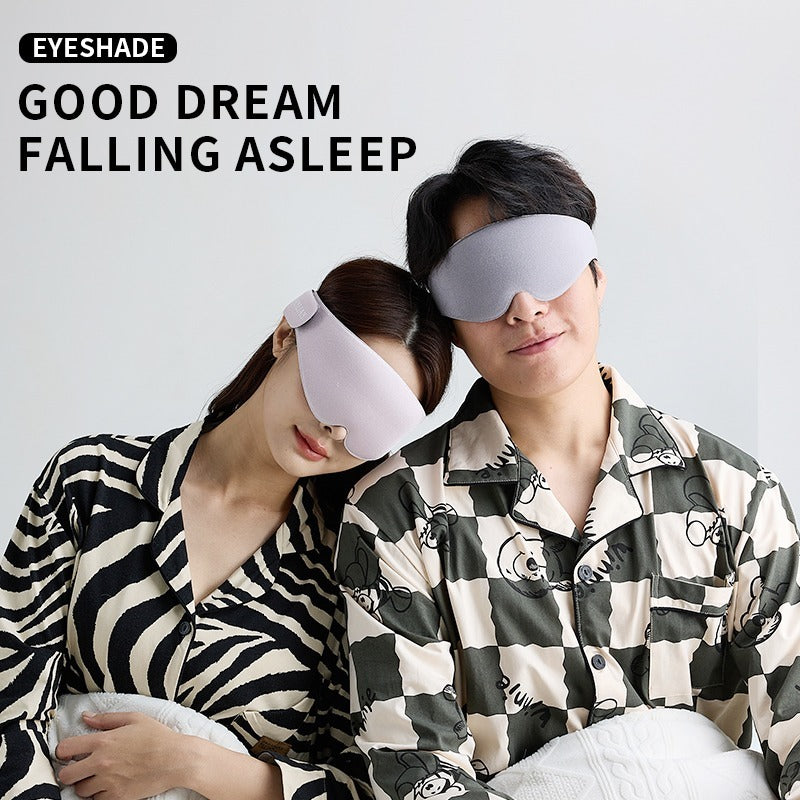 Two people wearing sleep masks with the text 'EYESHADE GOOD DREAM FALLING ASLEEP' on a light gray background.