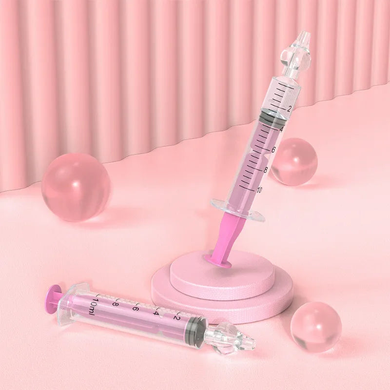 Pink syringes on a pink platform with a pink curtain background
