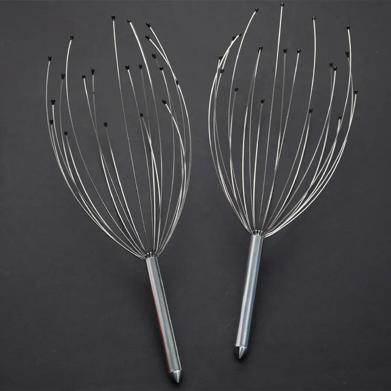 Two metal scalp massagers on a dark background