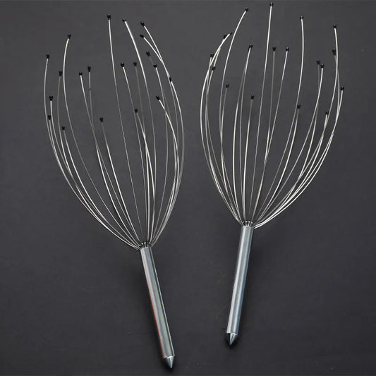Two metal scalp massagers on a dark background
