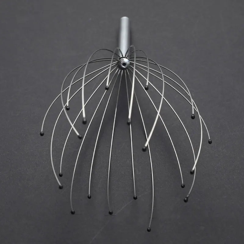 Metal head massager on a dark gray background