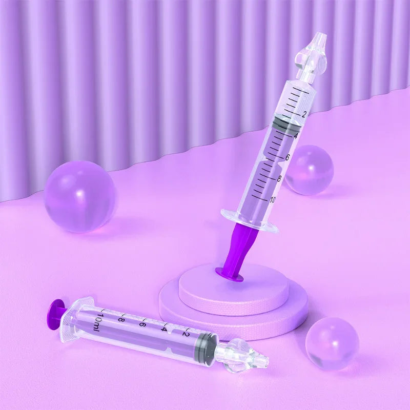 Two syringes with purple plungers on a pink surface with purple background