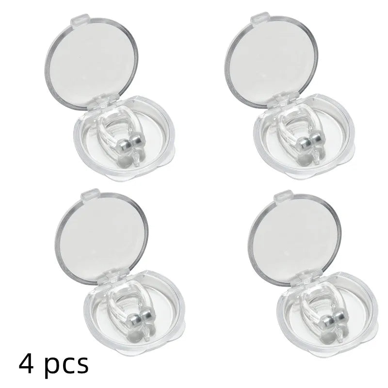 Four dental retainers in open clear cases on a white background