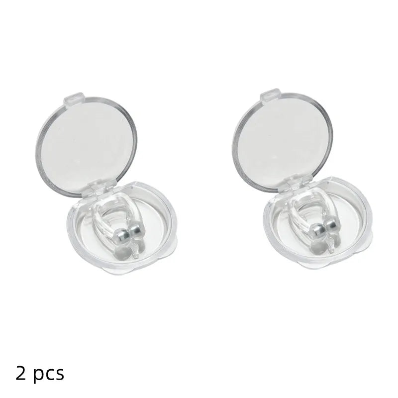 Two pairs of silver earrings in open cases on a white background